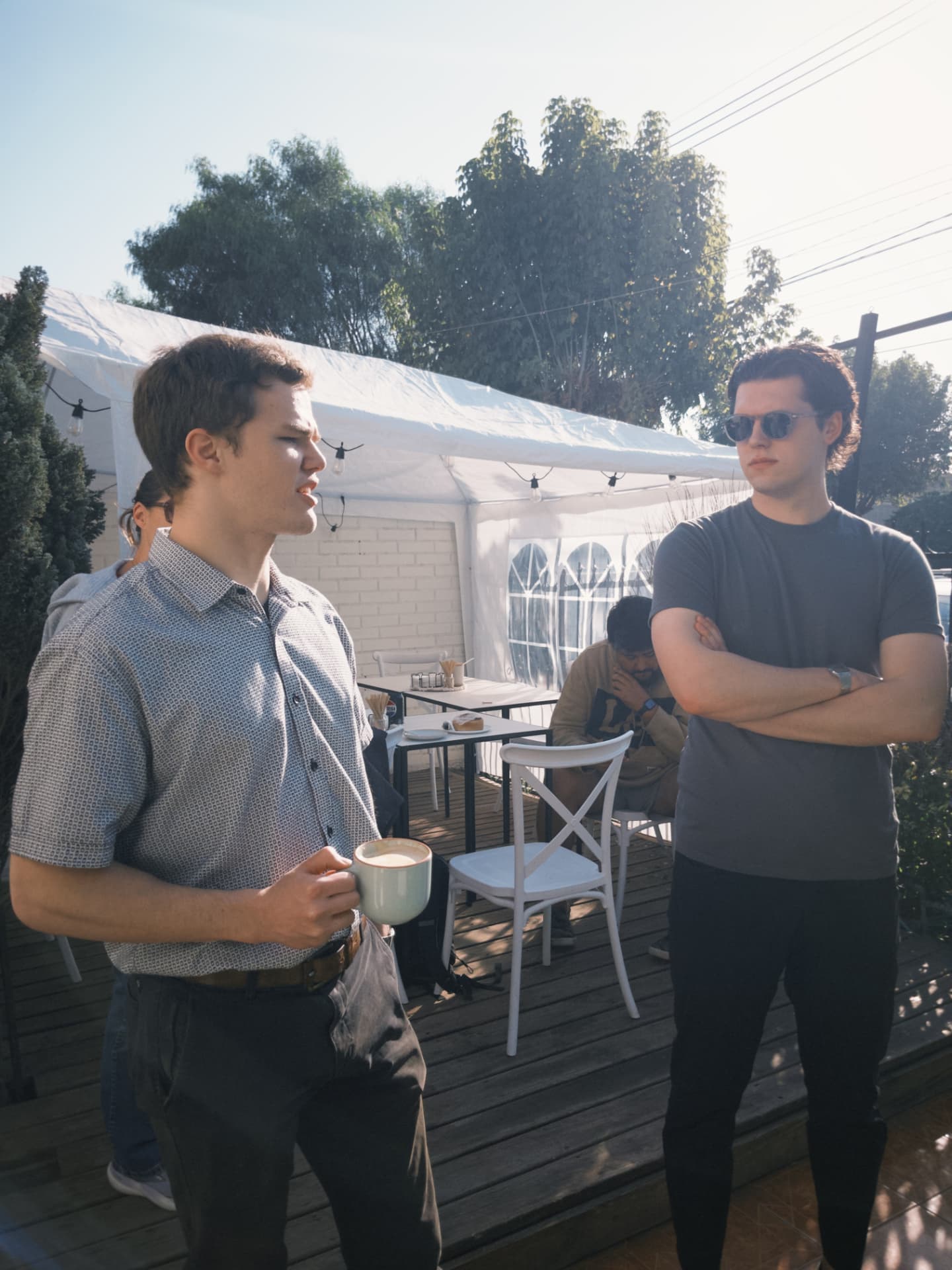 Two fellows talking one on one out on the patio